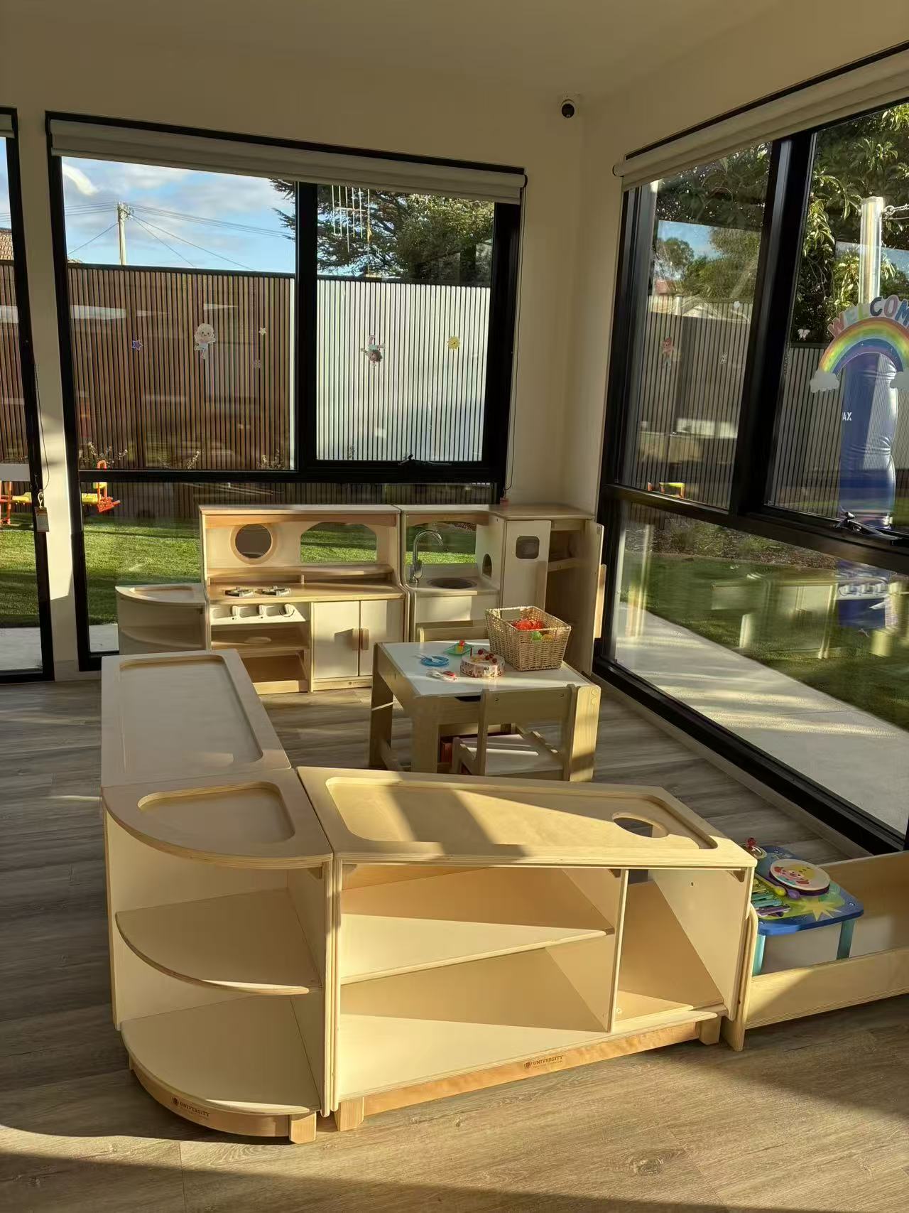 Toddler discovery zone with sensory trays and wooden play kitchen